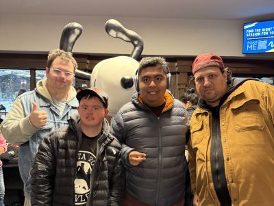 four individuals standing together