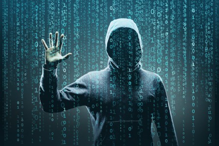 hooded figure with binary code running down the page