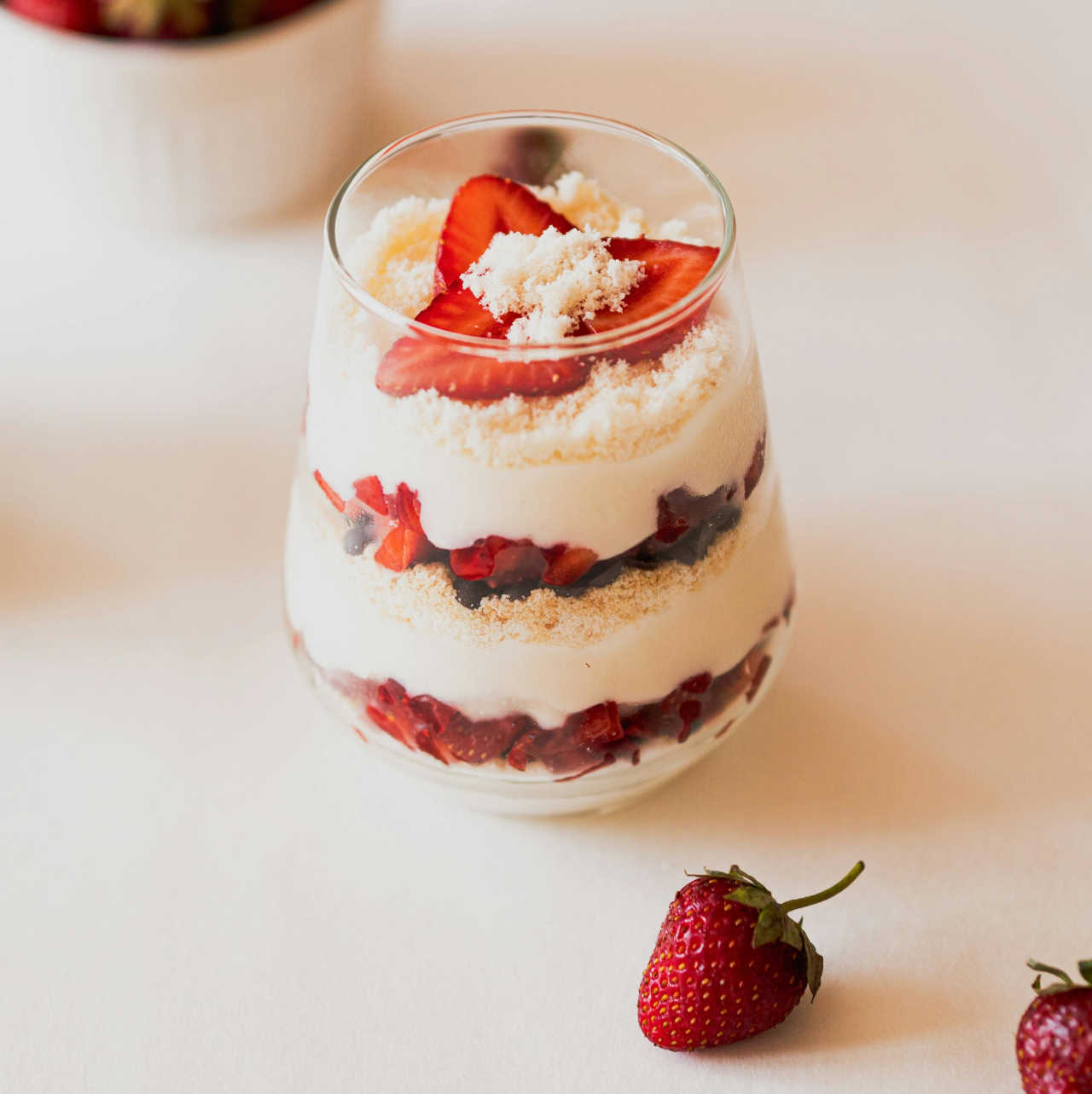 Picture of a glass filled with layers of yogurt and berries.