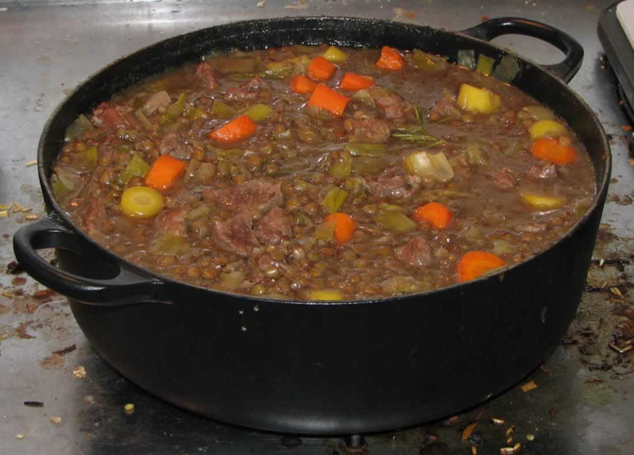 Picture of a dutch oven filled with stewed meat and vegetables.
