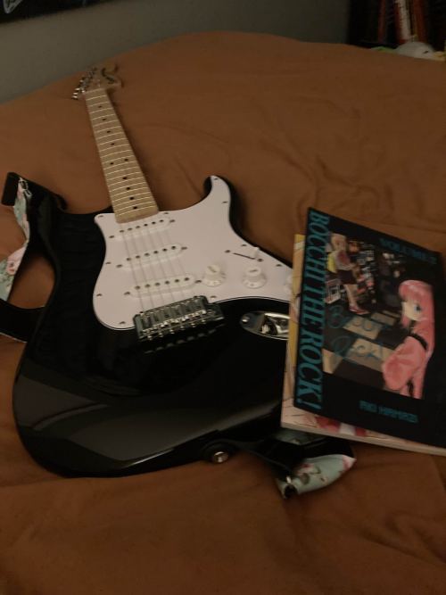 Guitar on bed