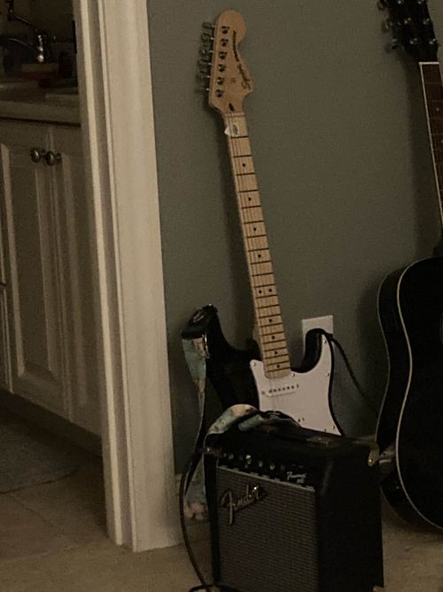 Guitar leaning on wall