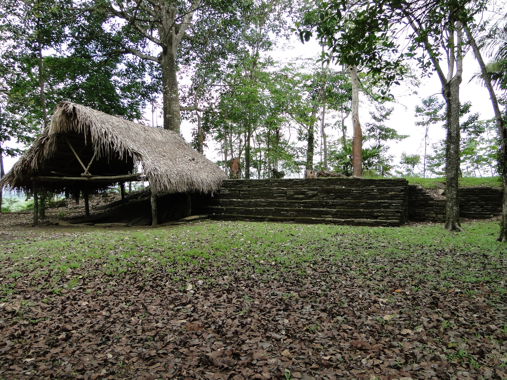 A recreation Mayan home, with an original tomb structure next to it.