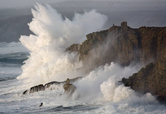Dramatic ocean waves crashing on rocks